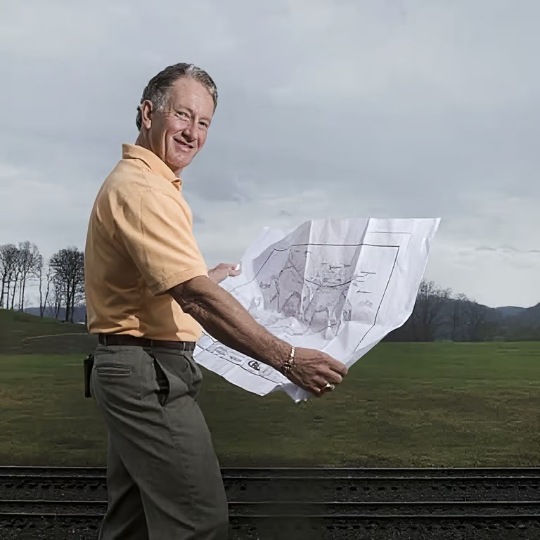 Joe Hollingsworth Jr. reviewing development plans in the field